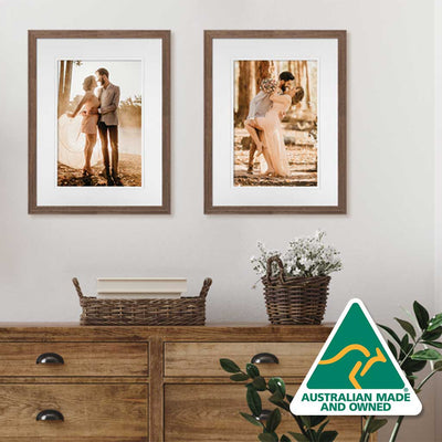 pair of wooden chestnut photo frames on wall