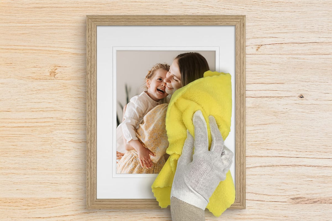 Framed photo being cleaned with a cloth