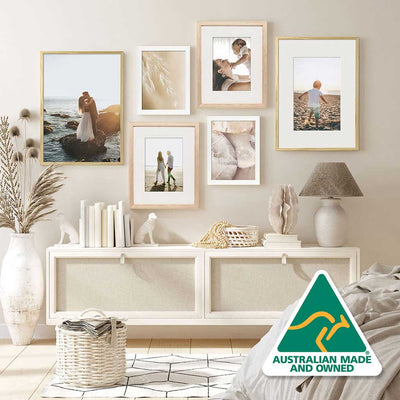 Arrangement of Timber Photo Frames on a Bedroom Wall