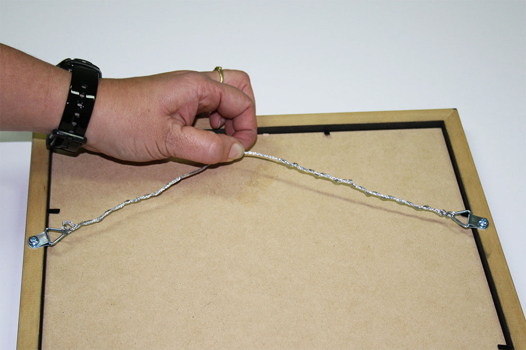 wire being attached to a picture frame