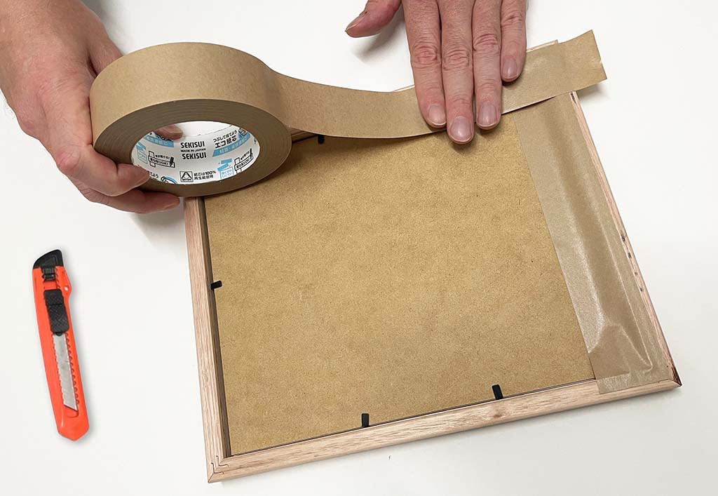 Sealing the back of a picture frame with frame sealing tape