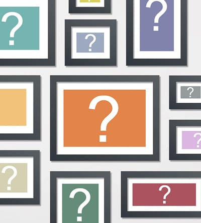 Wall display of black framed prints with question marks